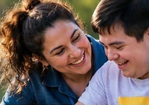 Support worker and young man sharing a laugh outdoors