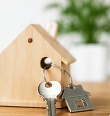Wooden model house with a set of house keys