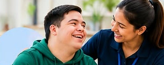 Young man laughing with his support worker